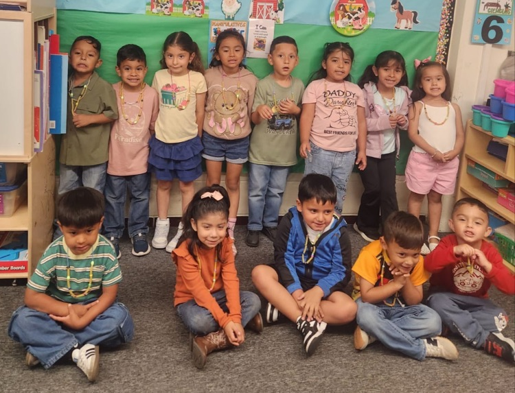 students wearing noodle necklaces