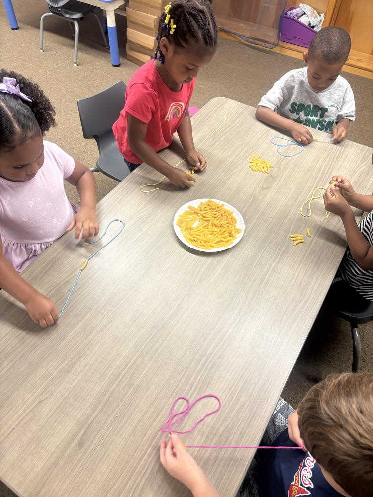 students wearing noodle necklaces