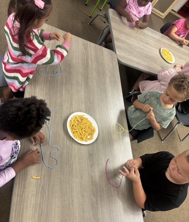 students wearing noodle necklaces