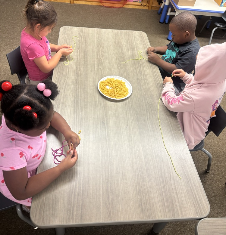students wearing noodle necklaces