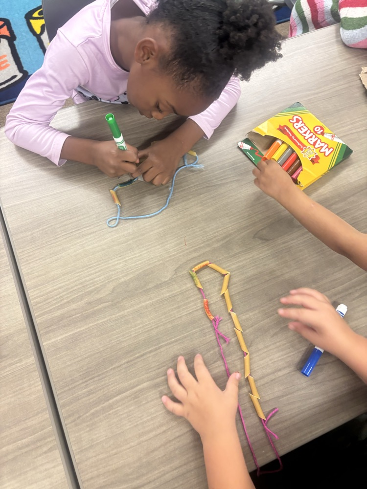 students wearing noodle necklaces