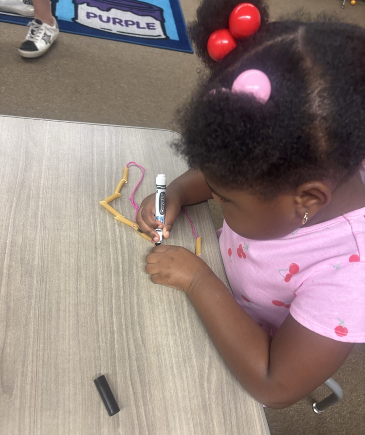 students wearing noodle necklaces