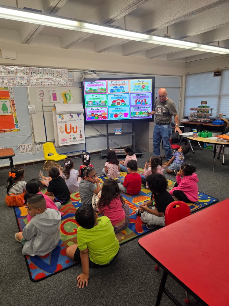 students sitting in class on the floor learning