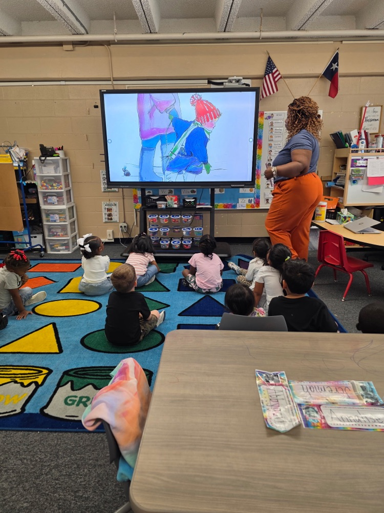 students sitting in class on the floor learning