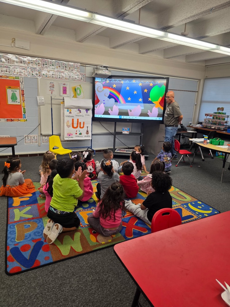 students sitting in class on the floor learning