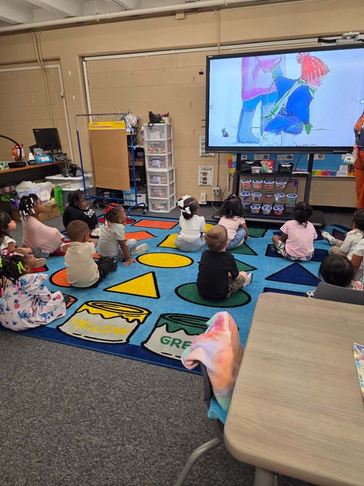 students sitting in class on the floor learning
