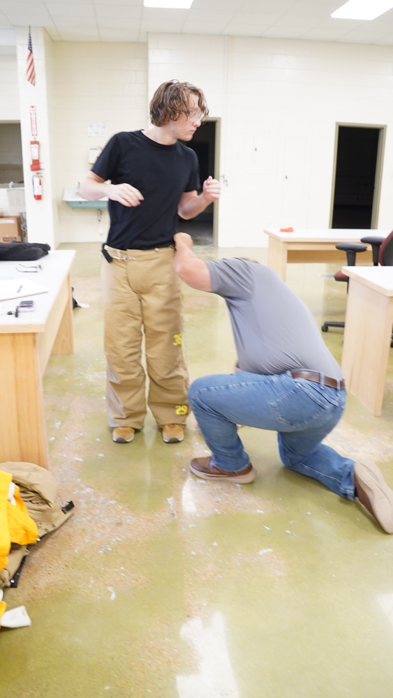 Firefighting program student gets fitted for his gear.