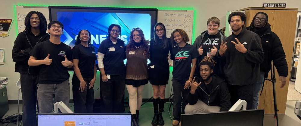 TV And Media student pose with Channel 8 representative