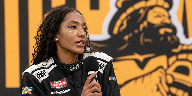 NASCAR Truck Series driver and Highland Springs High School graduate Dystany Spurlock speaks in front of a Highland Springs logo at a press conference at the school on Thursday, Aug. 13, 2026.