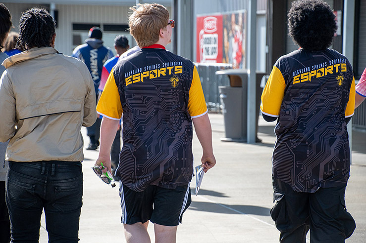 Student athletes from Highland Springs High School walk to their next event sporting their colorful esports jerseys. 