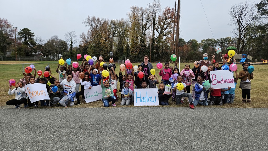2nd grade students stand with their balloons