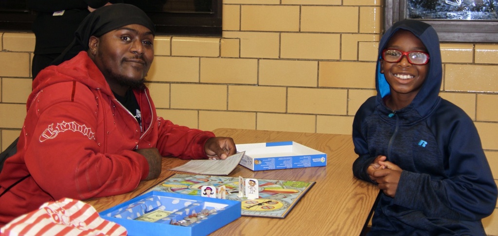Student and their family play a game together.