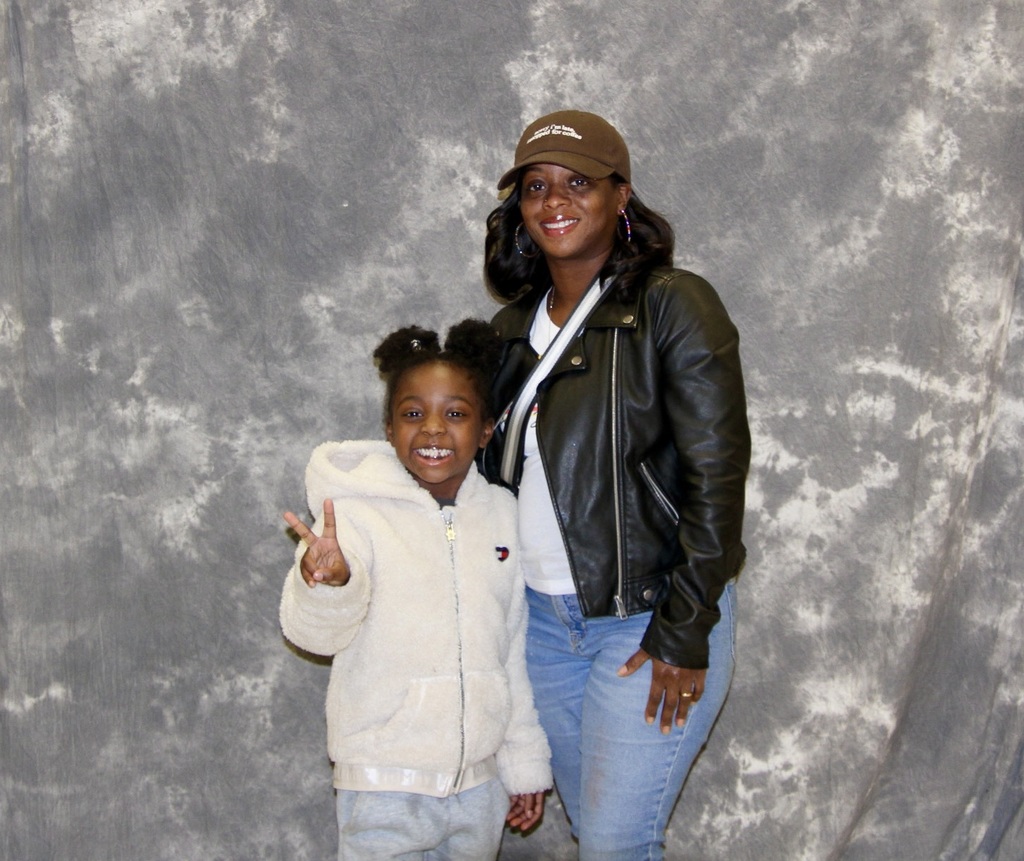 Student takes a picture with her family.