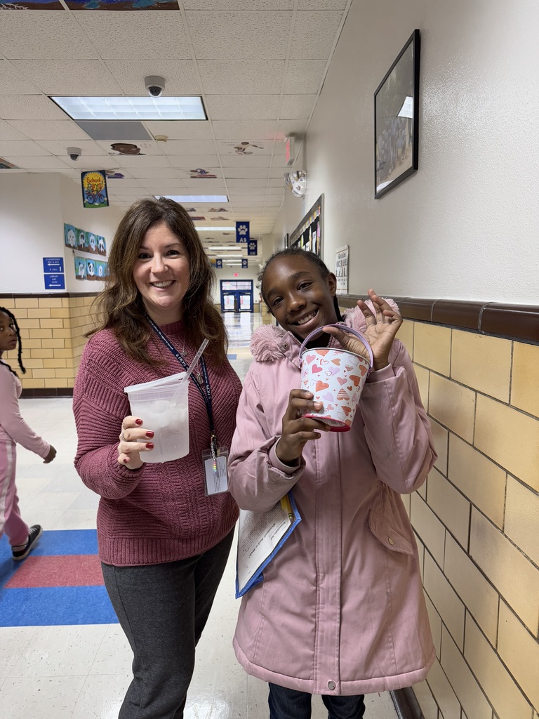 Ms. D'Amato and a student show off their buckets.