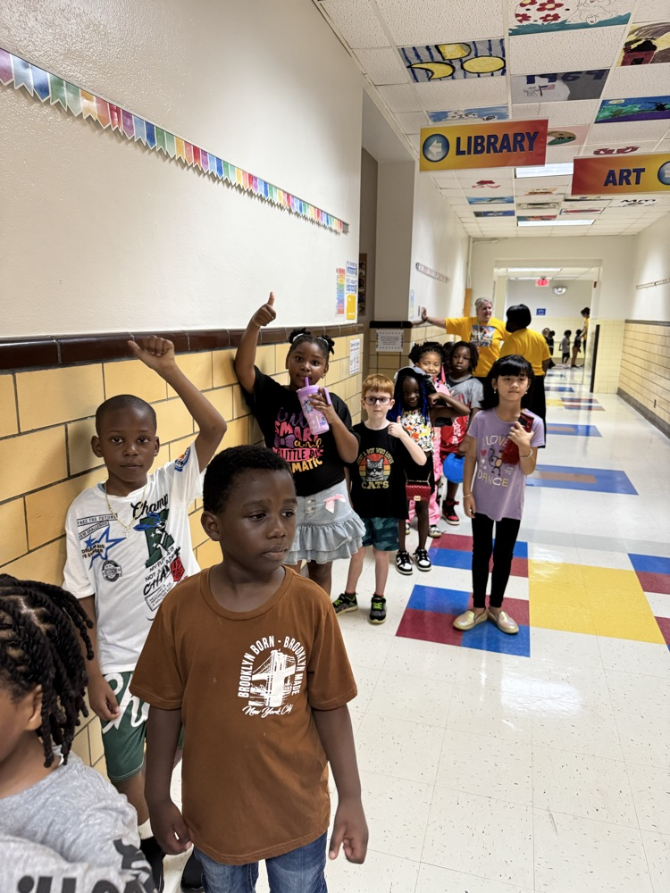 students give thumbs up in line