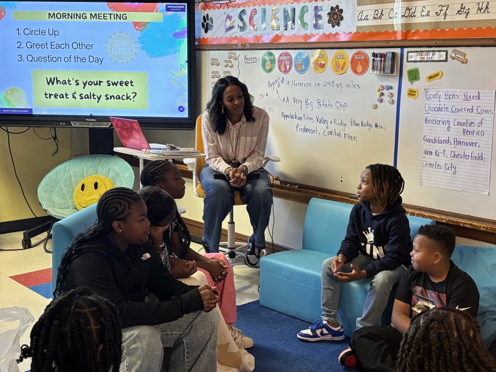 Teacher leads morning meeting on the carpet with her 5th grade students.