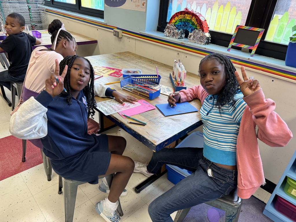 Students show peace signs while they start their art portfolios.