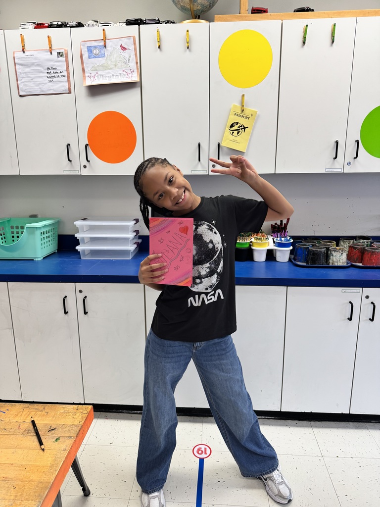 A student shows off her artwork.