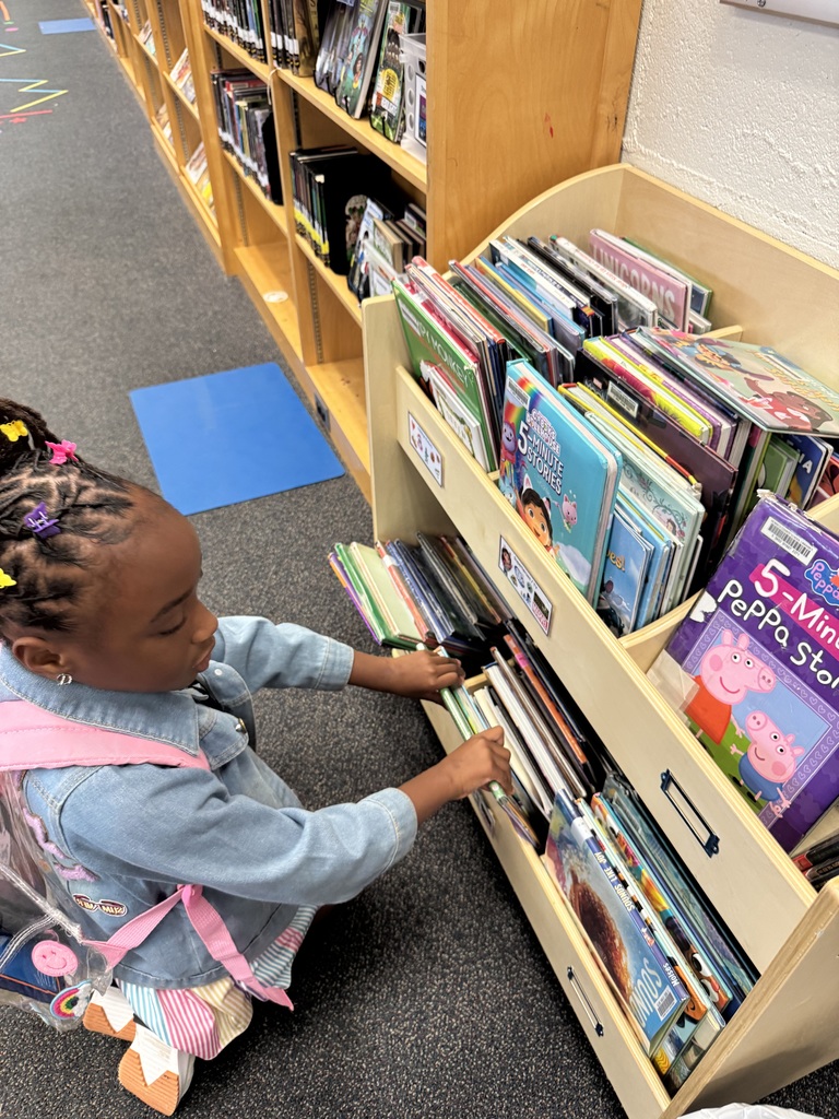 The first student checks out a library book. 