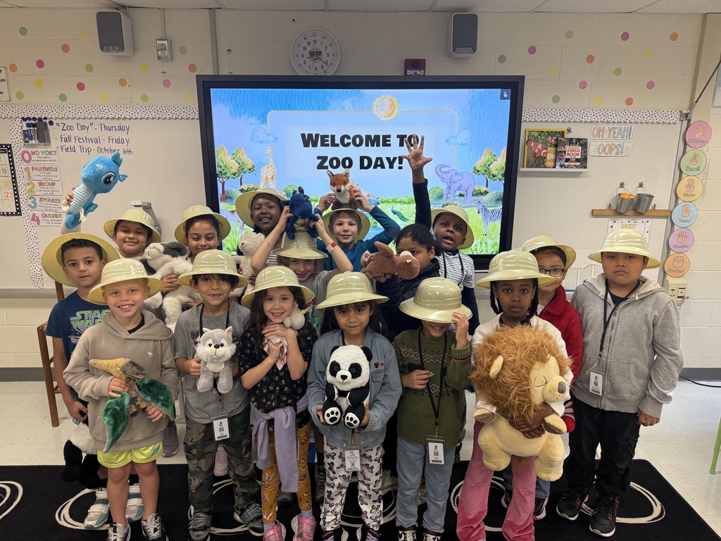 Ms. Anderson's class showing their stuffed animals in zookeeper hats!