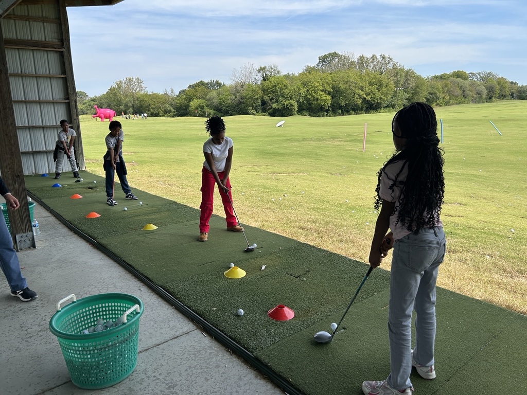 5th graders stand with their clubs, ready to put.