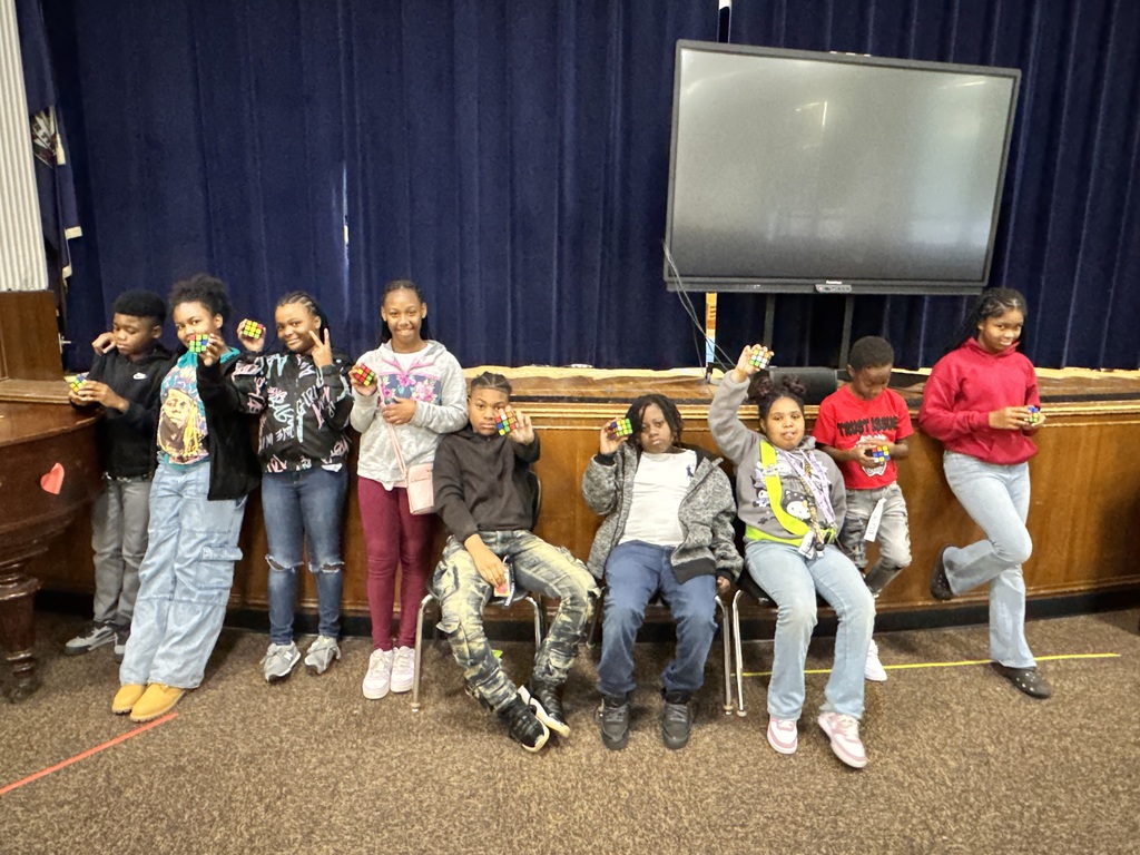 Students hold up their Rubik's cubes.