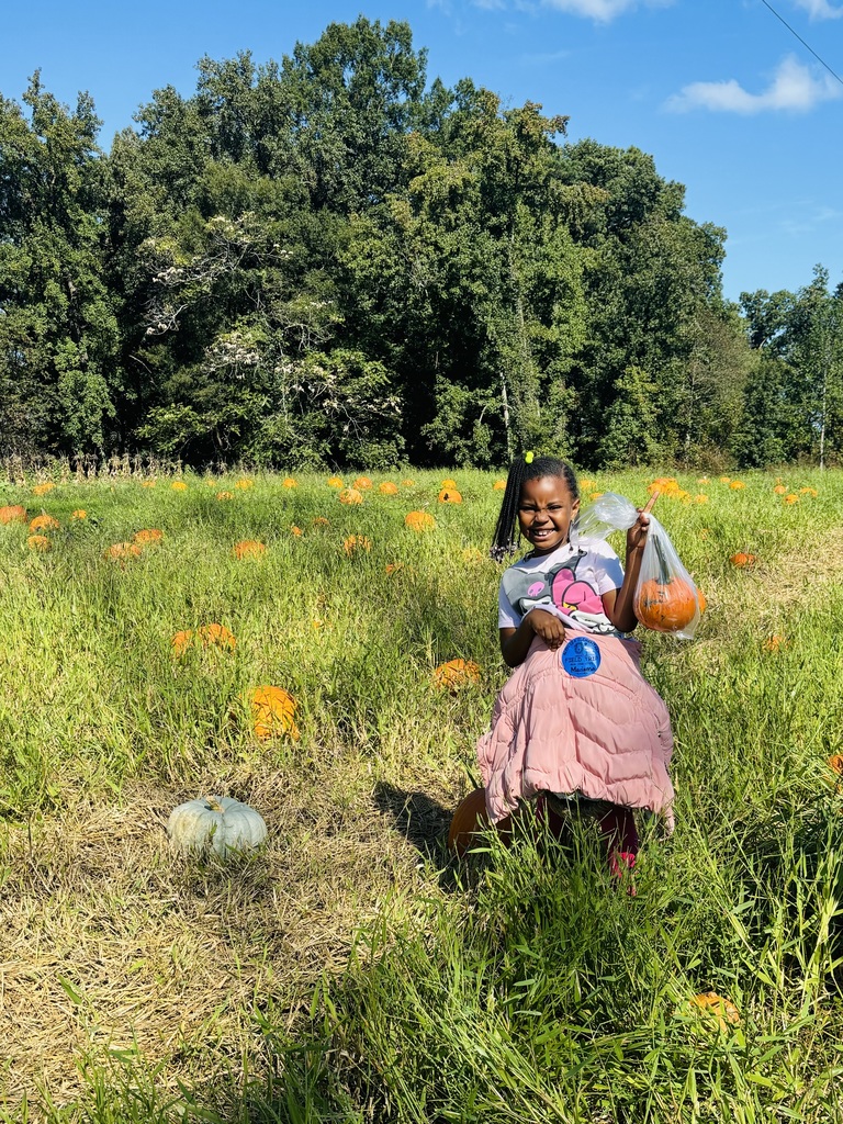 Student shows the pumpkin she selected.