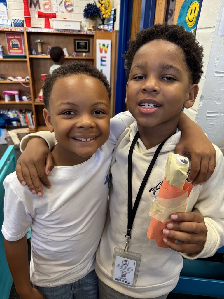 Two students hold a creepy carrot.