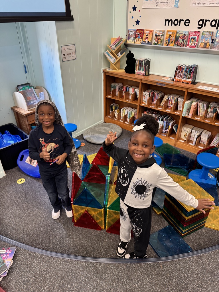 Students show off their barn-castle.