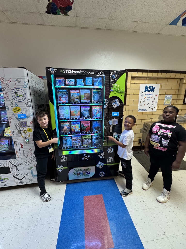 Students stand at our new vending machine.