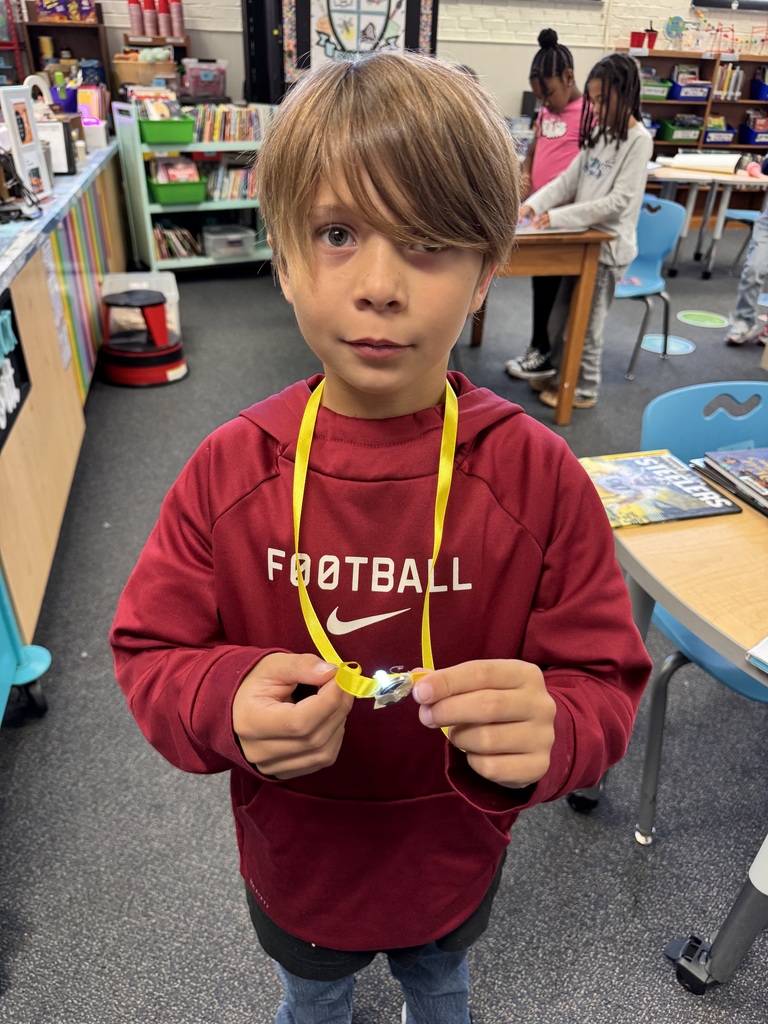 Student shows off their light necklace.