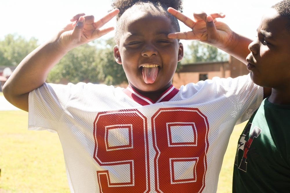 A student makes double peace signs.
