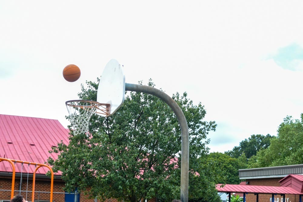 Basketball enters the hoop.