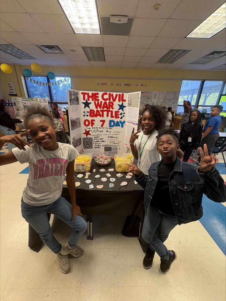 Students stand in front of their poster.