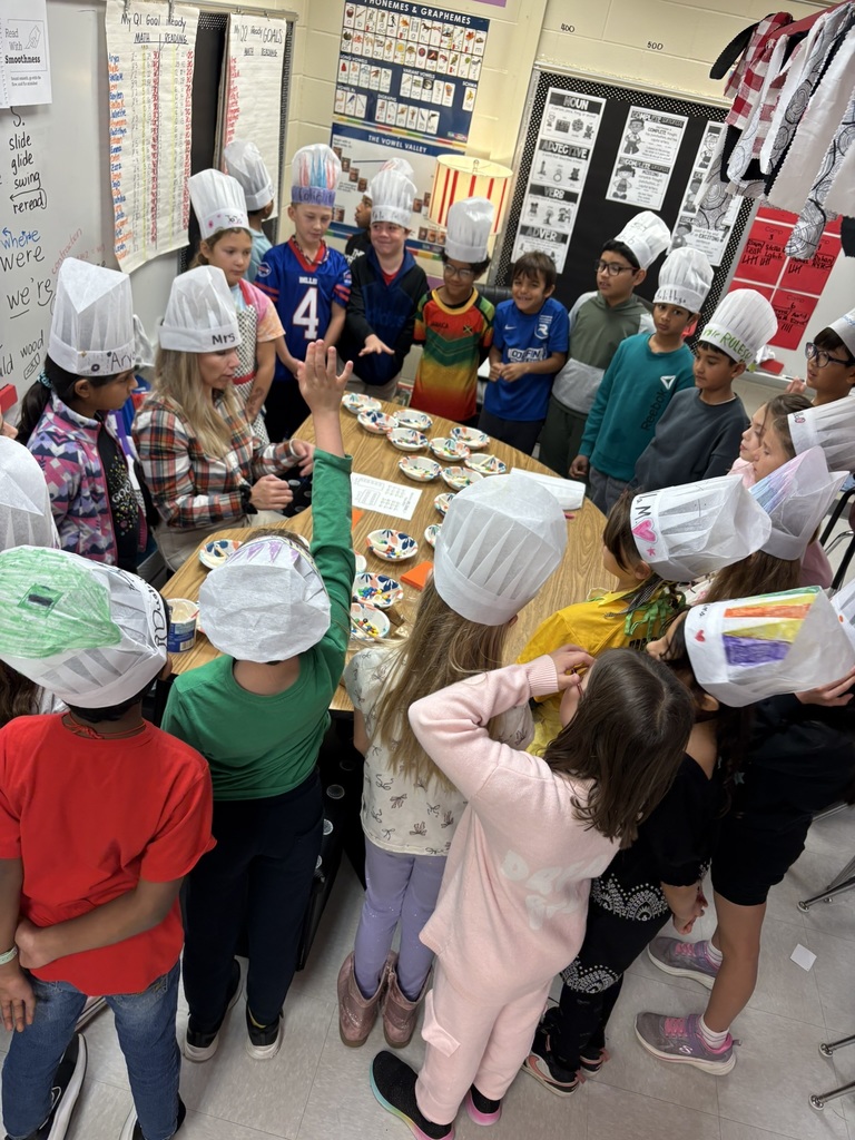 students gathered around teacher wearing chef hats
