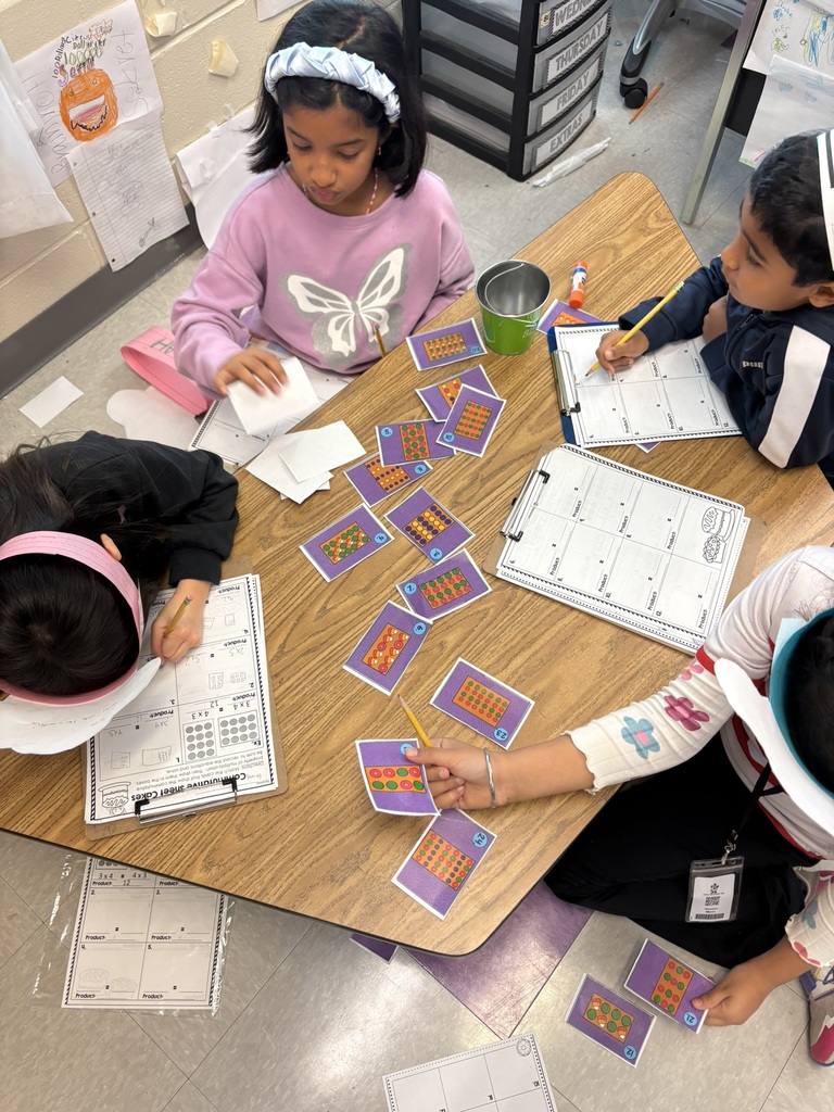 students learning with cards wearing bakery hats