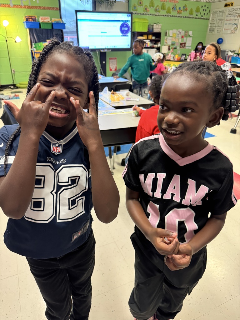 Two students showcase their jerseys.