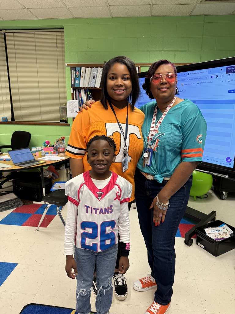 Student and teachers show off their team jerseys.