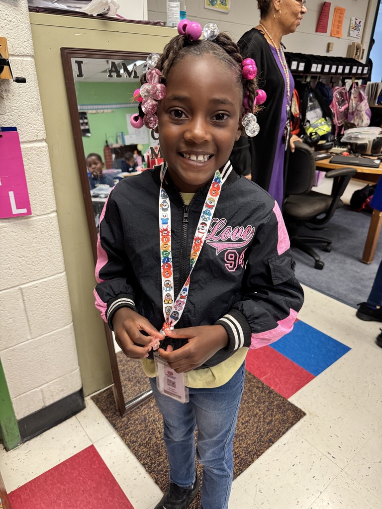 Student stands in a team jacket.