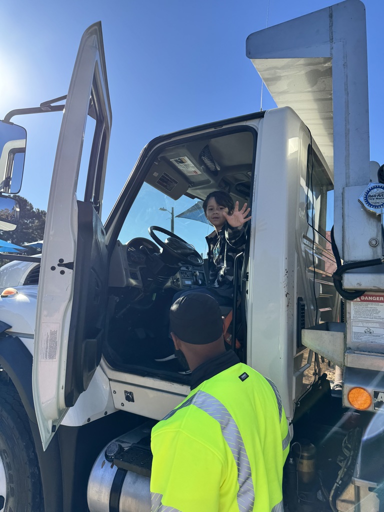 Student waves from inside a truck.