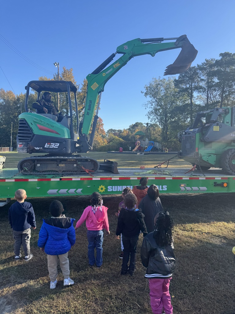 Students watch as the excavator is demonstrated.