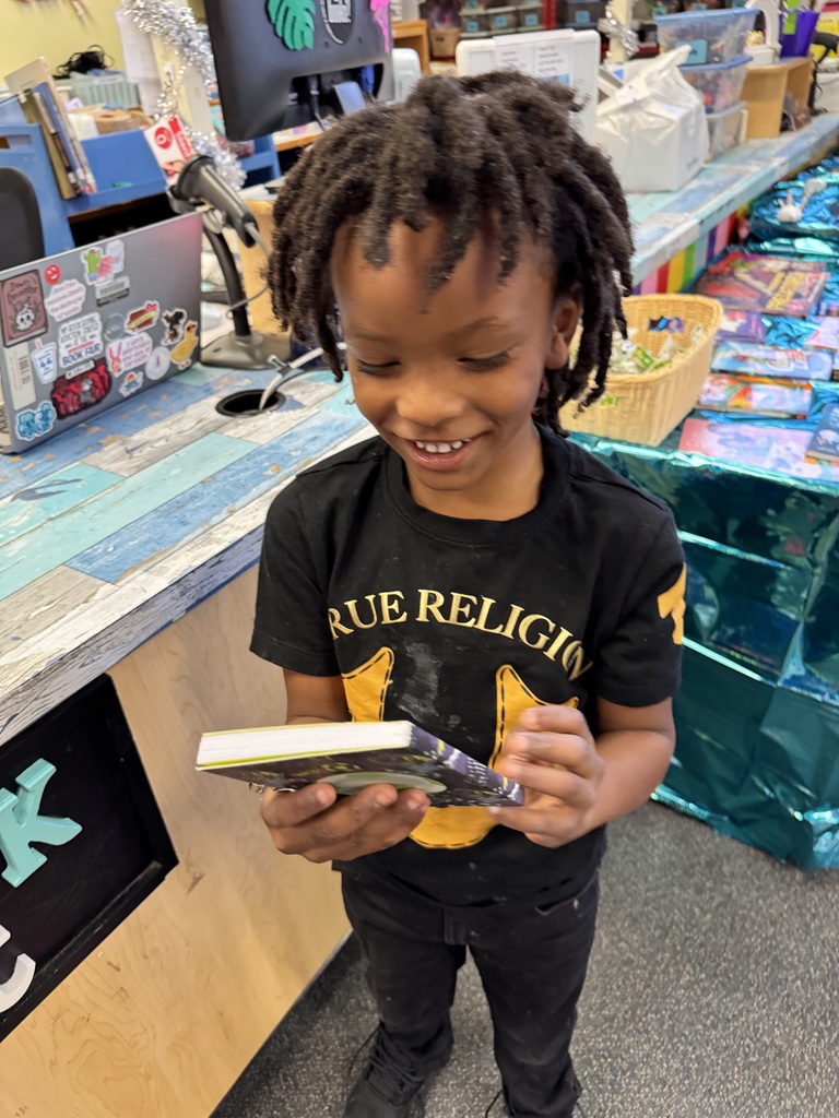 Student looks at a diary that he selected for Wish Day.