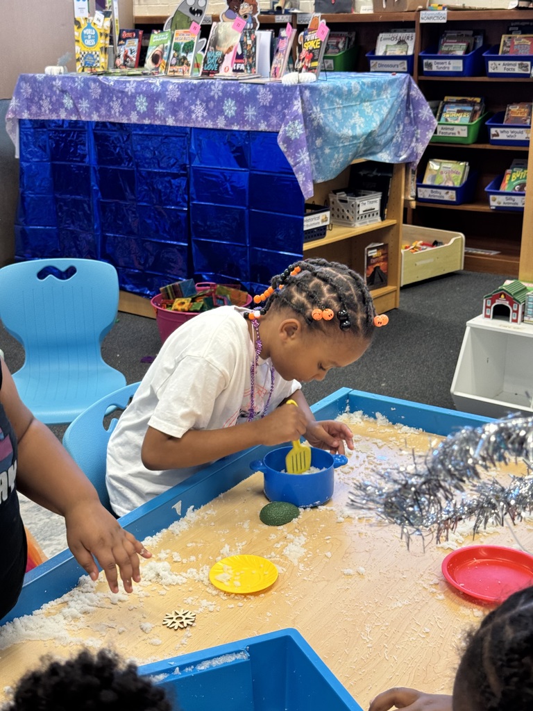 Student mixes fake snow in a pot.