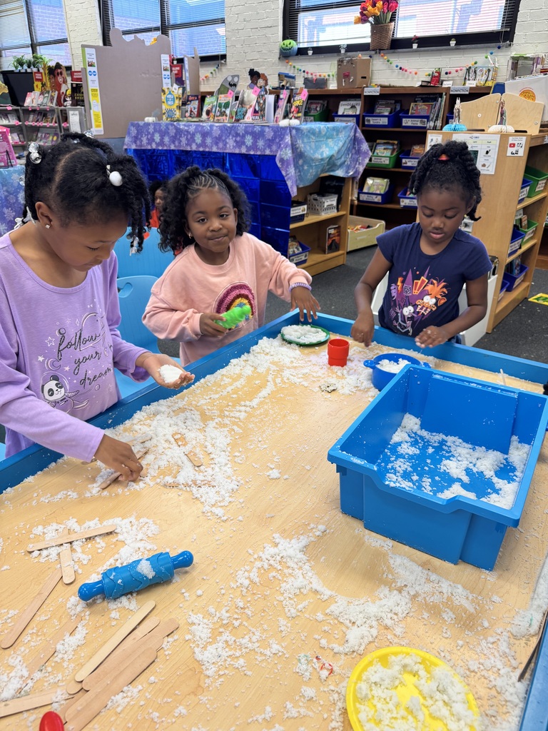 Kindergarten students explore fake snow together.