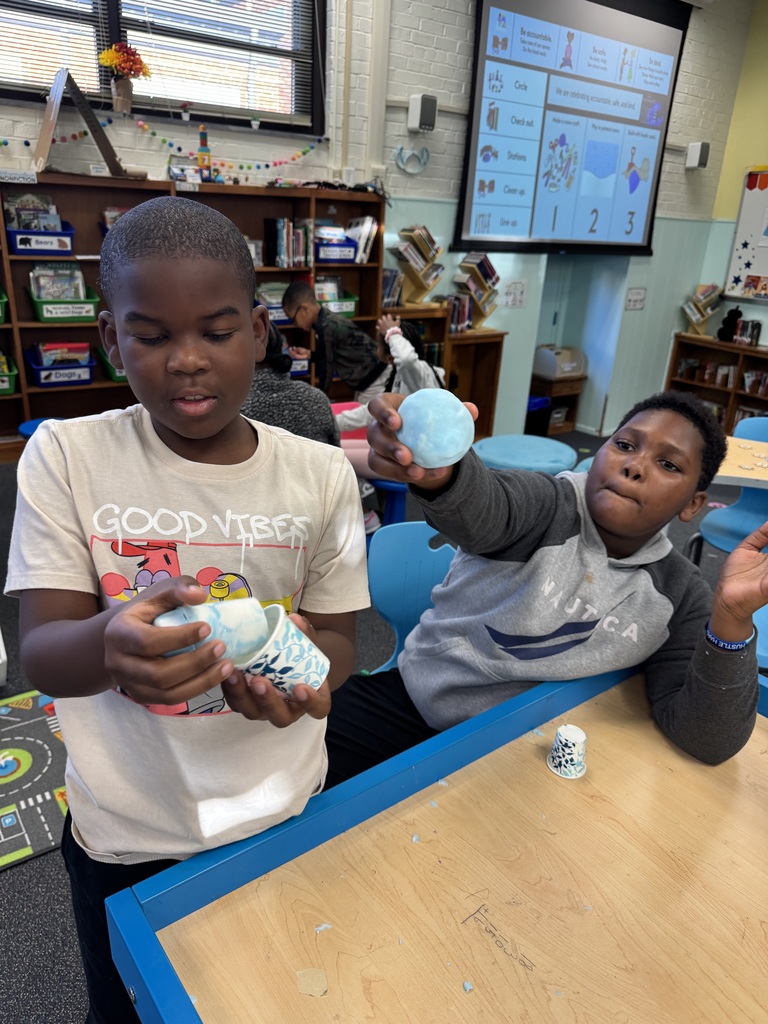 Students show off the snowballs they created.