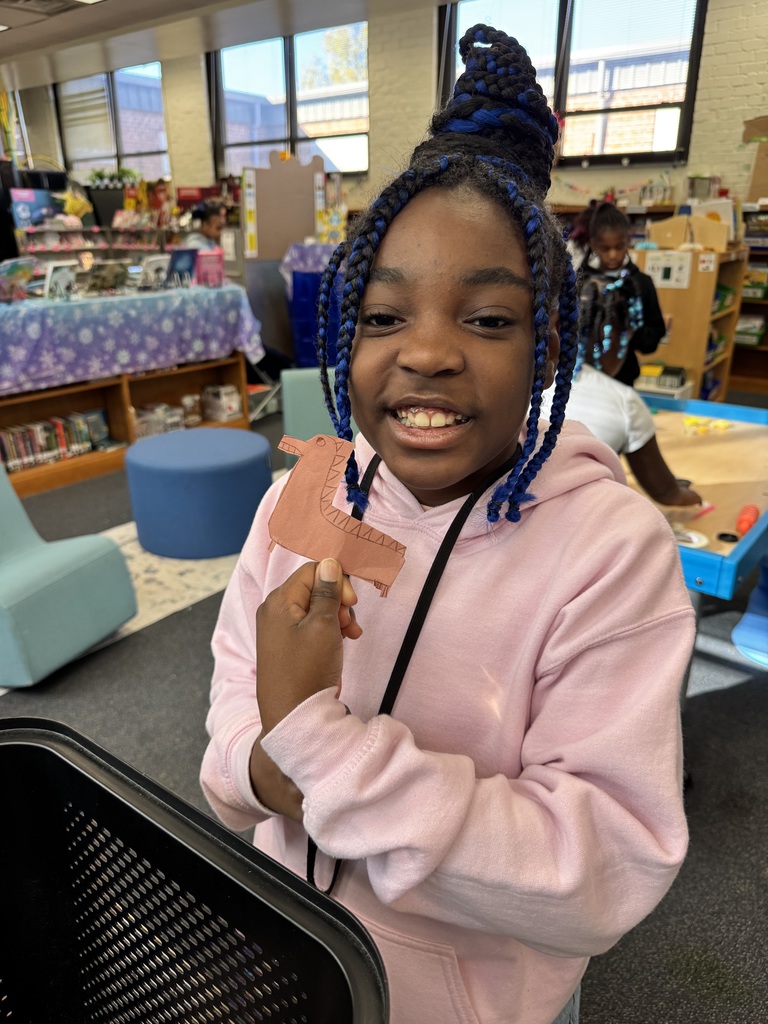 A student created a dinosaur puppet.