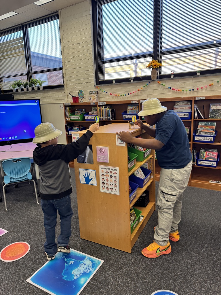 Students created their own dinosaur hunt with magnifying glasses.