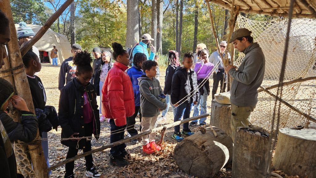 Students listen as he discusses how different materials were made.