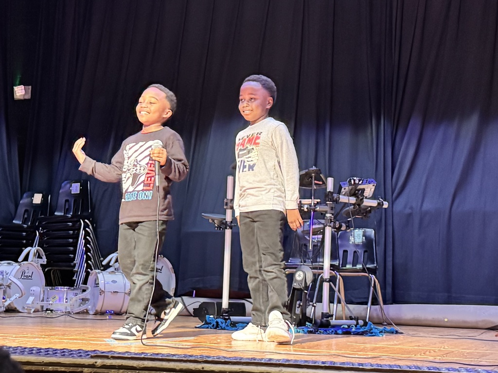 Two students perform an original song.
