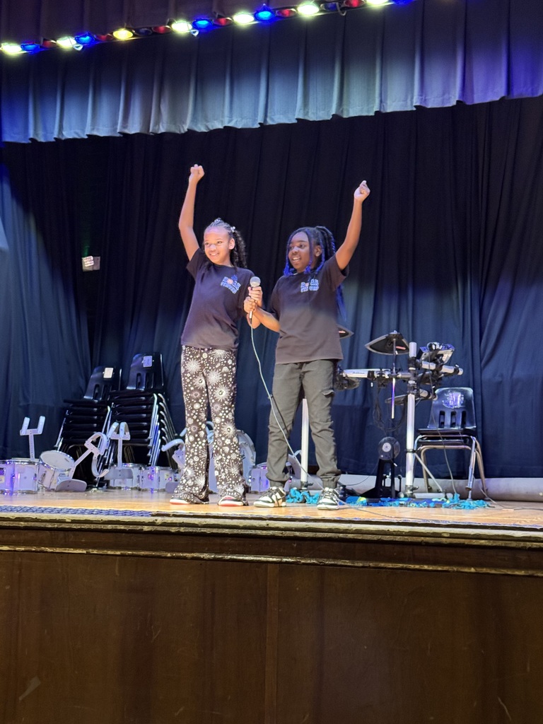 Two students hold hands at the beginning of their performance.